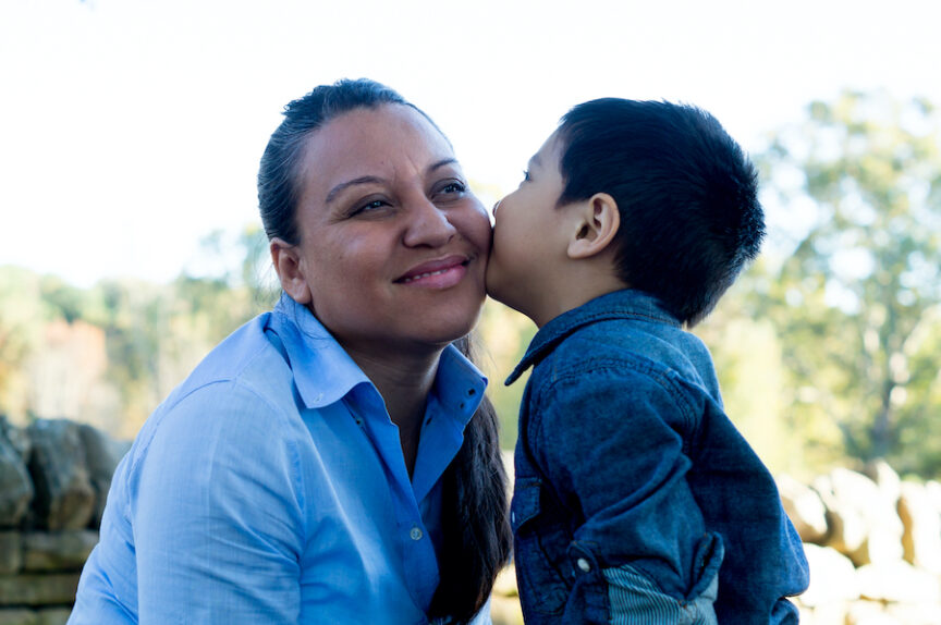 Young son giving a kiss to his mother